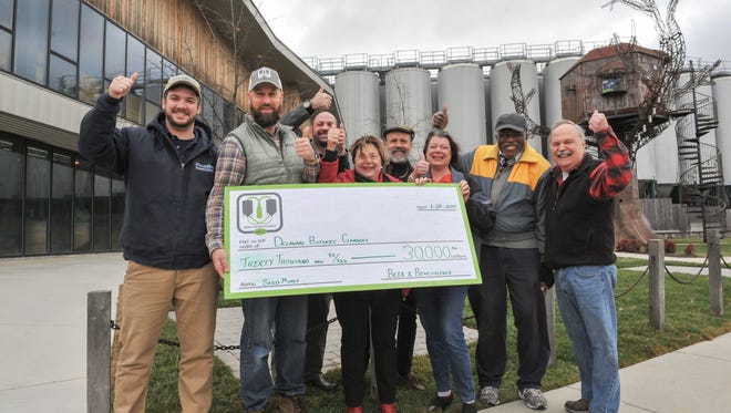 Mark Carter (second from left), director of Dogfish Head’s Beer & Benevolence program, presented a check for $30,000 to the Delaware Botanic Gardens at the brewery in Milton. Tyler Hammond, director of operations for Envirotech Environmental Consulting, is at the far left. Also pictured are DBG leaders Gregg Tepper (third from left), Sheryl Swed, Henry DeWitt, Janet Point, Peter Carter, and Raymond Sander.