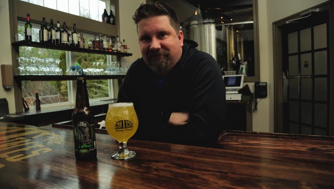 Eric Camper, head brewer at Tall Tales poses with Key’d from his Liquid Denial special release series.
