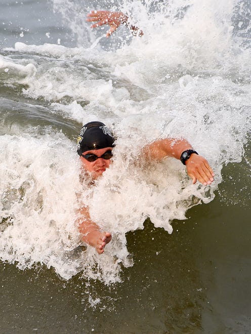Matt Kenny anchors the run-swim-run relay event as Ocean City Beach Patrol wins the race.