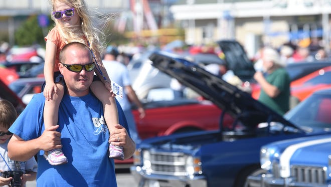 Eddie and Savannah Hornberger of Pasadena, Maryland, check out more than 1,500 cars, trucks and classic cars and hot rods lining the Inlet parking lot during Endless Summer Cruisin' 2017 on Saturday, Oct. 7, 2017.
