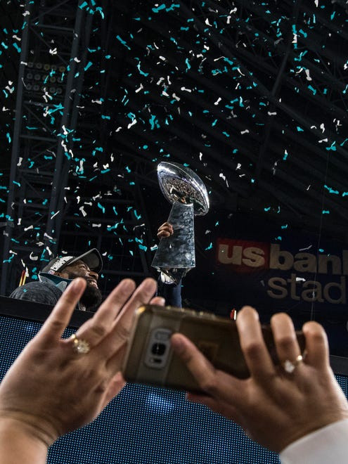 The Vince Lombardi Trophy is photographed by a fan Sunday at US Bank Stadium.