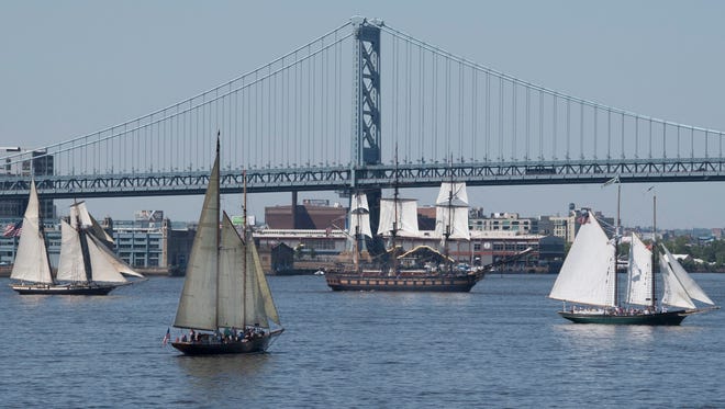 Tall ships make their way up the Delaware River near the Benjamin Franklin bridge during the Parade of Sails in Philadelphia, Thursday, May 24, 2018. The visiting tall ships are part of a three-day Philadelphia and Camden waterfront festival. (Jose F. Moreno/The Philadelphia Inquirer via AP)