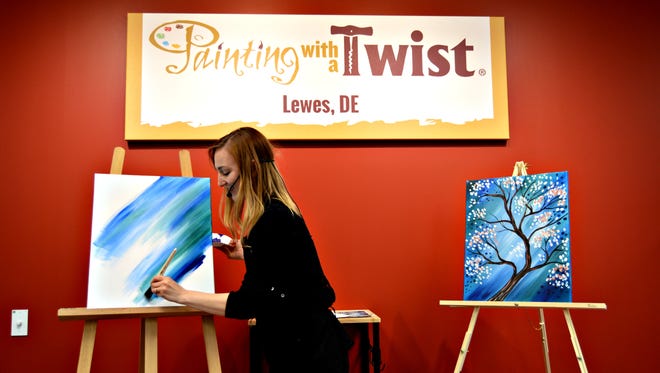 Katie Champagne leads the grand opening class at Painting with a Twist in Lewes, April 6. Painting with a Twist will participate in Rehoboth Beach's Beach Goes Blue event in June.