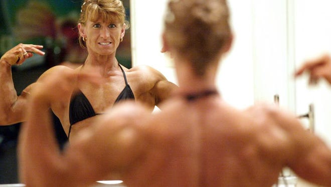 Nancy Perino from Monroeville, NJ, practices her pose in front of the mirror before the start of pre-judging in the 2005 NPC Natural NorEaster Bodybuilding, Fitness & Figure Championships on Saturday, Sept. 24, 2005 at Kahunaville.