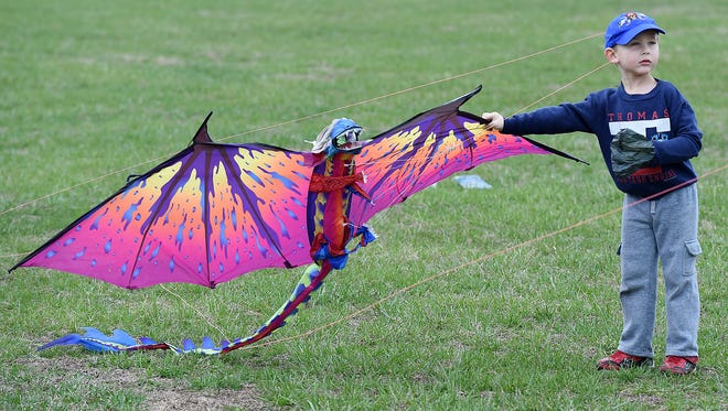 4 year old Archer Clarkson from Buffalo, NY with his dragon kite. Despite cloudy and rainy weather, the 48th Annual Kite Festival was held on Friday March 25th at Cape Henlopen State Park near Lewes with a good crowd on hand flying all kinds of kites and creations.