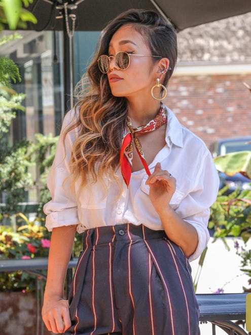 Rie Aoki wears a white shirt by God (Japanese Clothing Store), pants by Wanelo, sunglasses by Ray Ban and mules by Public Desire with a vintage scarf.