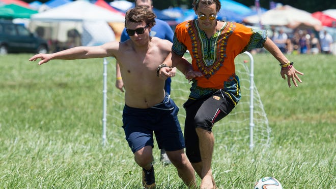 Jaz Quaranta, left, of Baltimore, Md., and Lorenzo Rolocut of Somers, Conn., play soccer on a field that the Firefly Music Festival set up in the north camping area, a request that festival goers ask for this year.