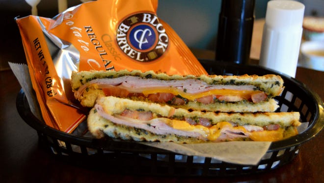 A homemade panini from A' Latte Soul, prepared with turkey, fresh tomato, cheddar cheese  and horseradish aioli.