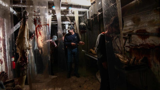 Guests move through a haunted house attraction at Frightland in Middletown in 2016.