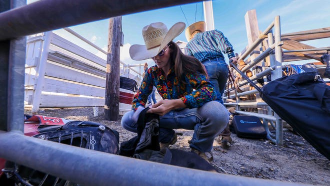 Lauren Ehrlich, of Wilmington, prepares for a bull riding competition in late July at the Cowtown Rodeo in Pilesgrove, New Jersey.