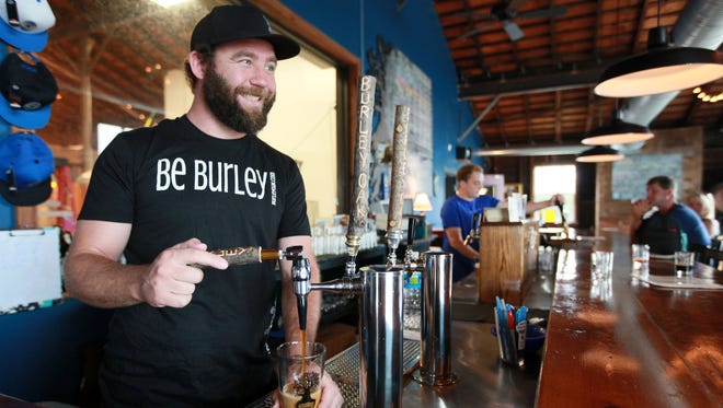 Burley Oak Brewery owner Bryan Brushmiller pours a beer at the brewery in downtown Berlin.