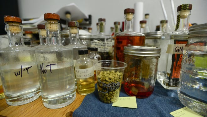 Dogfish Head's lead distiller Graham Hamblett's desk is full many different bottles of tests and concoctions at the Dogfish Head Distillery located in Milton, Del. on Friday, July 14, 2017.