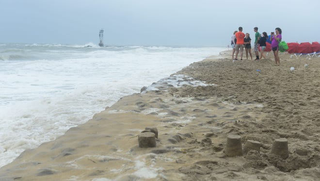 People are out looking at the large waves on the beaches in Ocean City where a summer nor'easter is passing through causing high winds, large waves and beach erosion on Saturday, July 29, 2017.