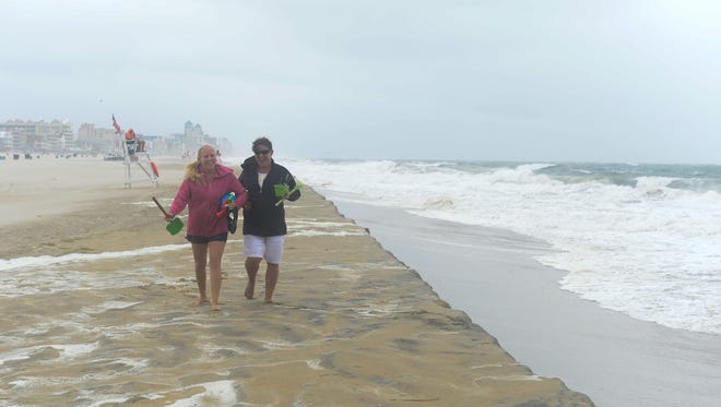 A couple of ladies play along the beaches in Ocean City where a summer nor'easter is passing through causing high winds, large waves and beach erosion on Saturday, July 29, 2017.