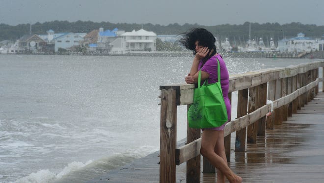A woman's hair blows in the high winds in Ocean City, Md. where a summer nor'easter is passing through causing high winds, large waves and beach erosion on Saturday, July 29, 2017.