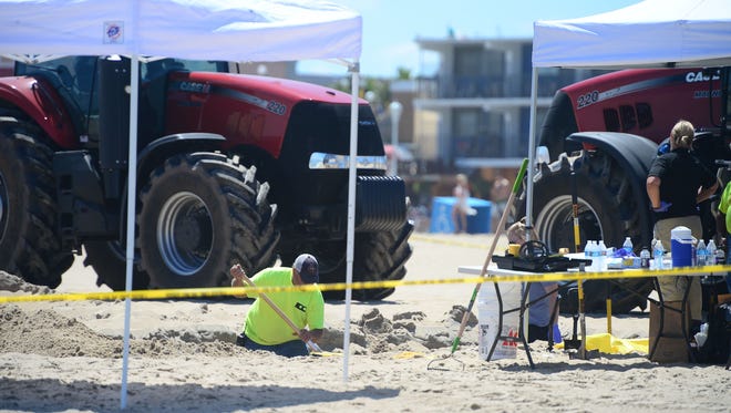 Ocean City Police and Forensics use are digging around the area where an unidentified body was found this morning around the 2nd Street beach in Ocean City, Md. on Monday, July 31, 2017.