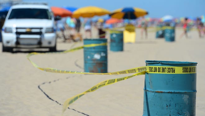 Police crime scene tape surrounds the beach where an unidentified body was found this morning around the 2nd Street beach in Ocean City, Md. on Monday, July 31, 2017.