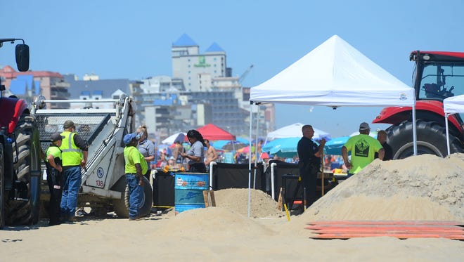 Ocean City Police and Forensics Units investigate the area where an unidentified body was found this morning around the 2nd Street beach in Ocean City, Md. on Monday, July 31, 2017.