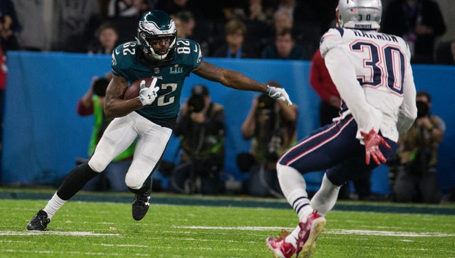 Eagles' Torrey Smith looks for a way around the Patriots' Duron Harmon Sunday at US Bank Stadium.
