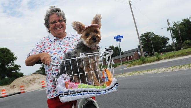 Linda Mears and her dog Precious go for a bike ride on Bay Avenue in Cape Charles, Va. on Tuesday, June 21, 2016.