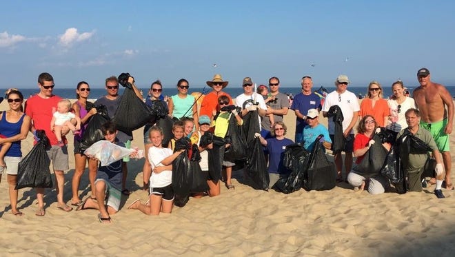 Volunteers line up with their trash collection after last year's Ocean Conservancy cleanup in Ocean City.