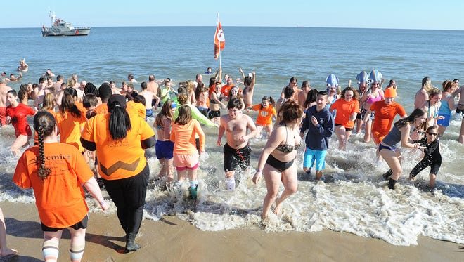 Ian Snitch, a senior at Middletown High School, leads the charge into the Atlantic for the 2017 Polar Bear Plunge. The MHS team was the largest assembled in the plunge's 26-year history.