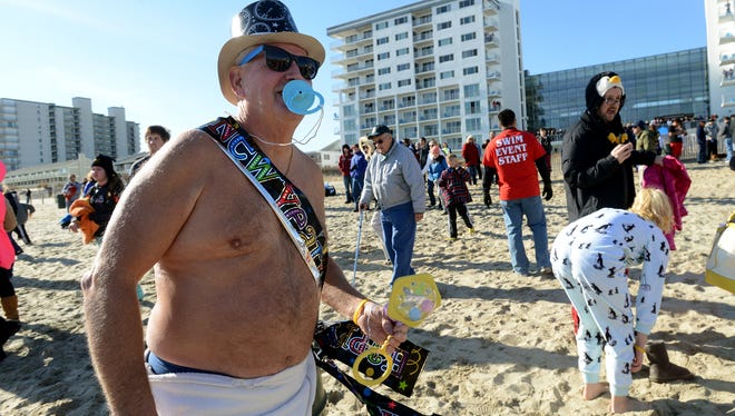 Dressed as baby New Year, Rick Moore of Glen Burnie prepares to take a dive into the Altantic Ocean Thursday afternoon during the AGH Penguin Swim in Ocean City.