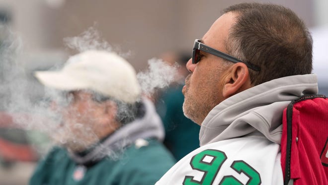 Dan Isdaner of Jupiter, FL tailgates and enjoys a cigar as he prepares for the Philadelphia Eagles to take on the visiting Minnesota Vikings in the NFC Championship game at Lincoln Financial Field.