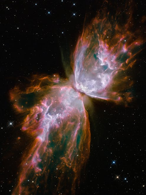 This image made by the NASA/ESA Hubble Space Telescope shows jets of gas heated to nearly 20,000 degrees Celsius traveling at more than 950,000 kilometres (59,000 miles) per hour streaming from they dying star NGC 6302, the "Butterfly Nebula" in the Milky Way galaxy. The star was once about five times the mass of the Sun. (NASA/ESA/Hubble SM4 ERO Team via AP) ORG XMIT: NY935