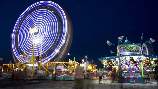 A ferris wheel at the Delaware State Fair glows through a long-exposure photograph on Friday night, July 24, 2015.