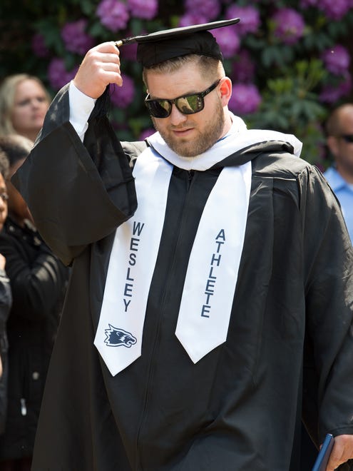 Matthew Alexander Schmidt moves his tassel after receiving his degree at the Wesley College Spring Commencement in Dover.  A total of 244 graduated.