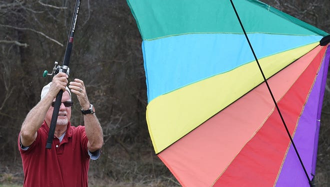 Nick Morris from Berlin, Md. uses a fishing pole to fly his kite as despite cloudy and rainy weather, the 48th Annual Kite Festival was held on Friday March 25th at Cape Henlopen State Park near Lewes with a good crowd on hand flying all kinds of kites and creations.