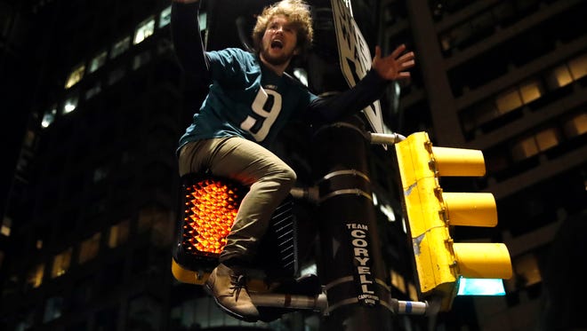 A Philadelphia Eagles fan celebrates the team's victory in the NFL Super Bowl 52 between the Philadelphia Eagles and the New England Patriots, Sunday, Feb. 4, 2018, in downtown Philadelphia.