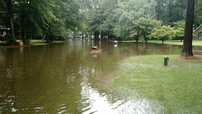 After torrential downpours early Saturday morning, parts of Salisbury — including outlying regions such as in Kilbirnie Estates, pictured here — are flooded.