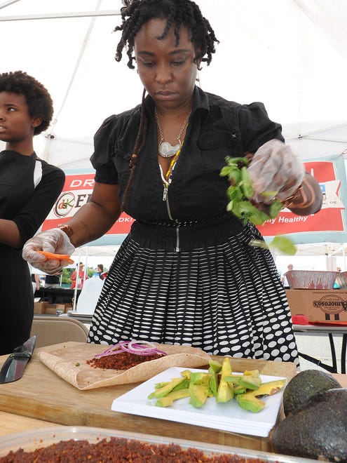 Wilmington's Drop Squad Kitchen's "Chief Food Scientist" Abundance Child makes a vegan wrap.