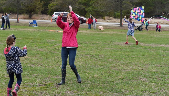 Stacy Lawson, with her daughter Grier, 5, both from Harbeson fly their kite, Despite cloudy and rainy weather, the 48th Annual Kite Festival was held on Friday March 25th at Cape Henlopen State Park near Lewes with a good crowd on hand flying all kinds of kites and creations.