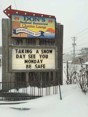 A sign outside of Don's Seafood in Chincoteague, Virginia, announces its closure for the day Saturday, Jan. 17, 2017, due to snow.