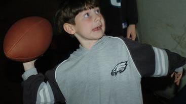 Jake Banner, 6, of Newark, gives his best try at throwing a football at the Eagles Draft party held at Kahunaville in 2004.