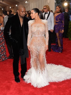 Kanye West, left, and Kim Kardashian arrive at The Metropolitan Museum of Art's Costume Institute benefit gala.