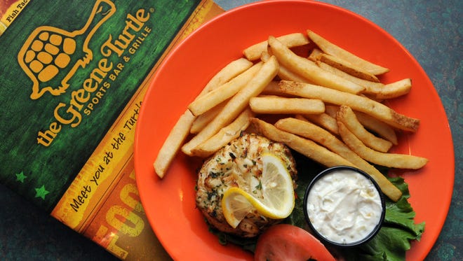 The crab cake made with jumbo lump crabmeat is served with fries at The Greene Turtle Sports Bar & Grille.