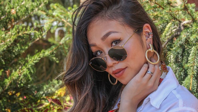 Dancer Rie Aoki wears a white shirt by God (Japanese Clothing Store), sunglasses by Ray Ban, and jewelry by Free People Sunday, July 2, 2017, at Brew HaHa in Greenville.