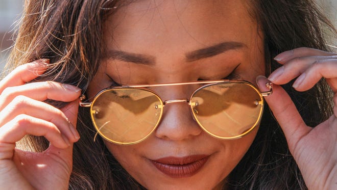 Dancer Rie Aoki poses for a photo while wearing Free People sunglasses Sunday, July 02, 2017, at Brew HaHa! in Greenville.