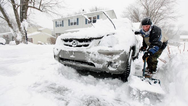 Andrew Mathe of Hockessin, Del. digs out over a foot of snow as the heavy snow storm hits the state and Gov. Jack Markell declares a state of emergency.  Saturday, Feb. 6, 2010.