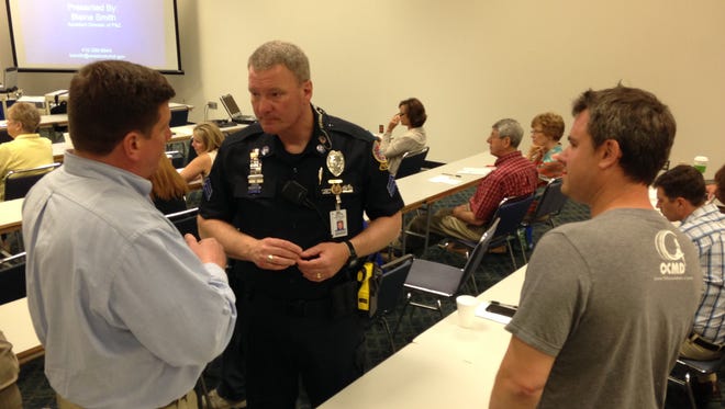 Ocean City Councilman Wayne Hartman (left) talks with Ocean City Police Department Sgt. Mark Paddack Tuesday while landlord Aaron Evans listens during a workshop at the Roland E. Powell Convention Center.