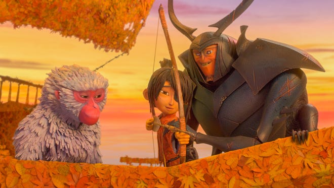 Monkey (left, voiced by Charlize Theron) watches as Beetle (Matthew McConaughey) teaches Kubo (Art Parkinson) how to shoot a bow in 'Kubo and the Two Strings.'