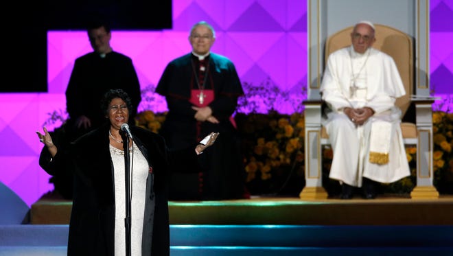 Aretha Franklin performs as Pope Francis is seated nearby during the Festival of Families, Saturday, Sept. 26, 2015, in Philadelphia.