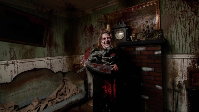 A haunted house actor prepares to scare guests at Frightland in Middletown last year.