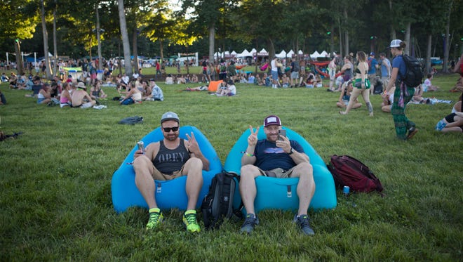 Festival goers ease their way into the first day of live music at Firefly Music Festival Thursday in Dover.
