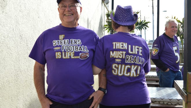 Jim and Sharon Kenney, of Westminster, show their Ravens pride on game day at Pit & Pub in Ocean City.