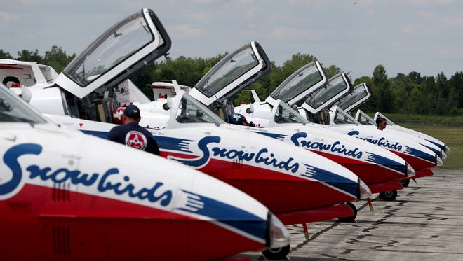 The Canadian Forces Snowbirds jets are lined up at the Willow Run Airport. The Snowbirds join the Skyhawks parachute team and the CF-18 jet in various demonstrations for the paying public to see and enjoy.